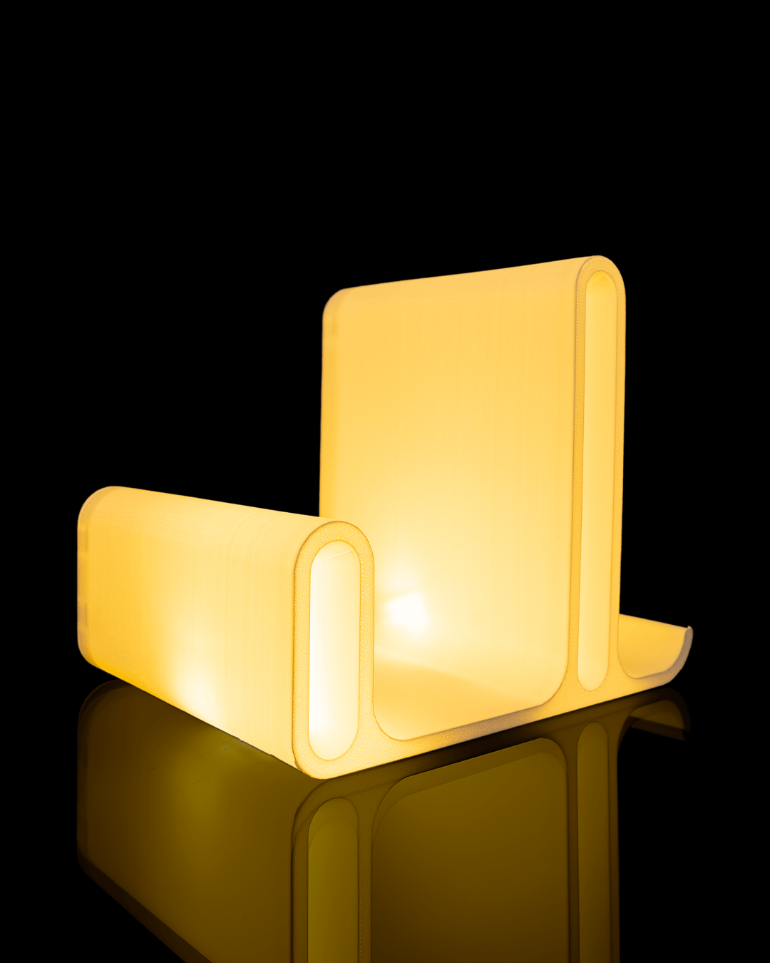 Glow Arc — a softly lit 3D-printed book and glasses holder — lit and glowing