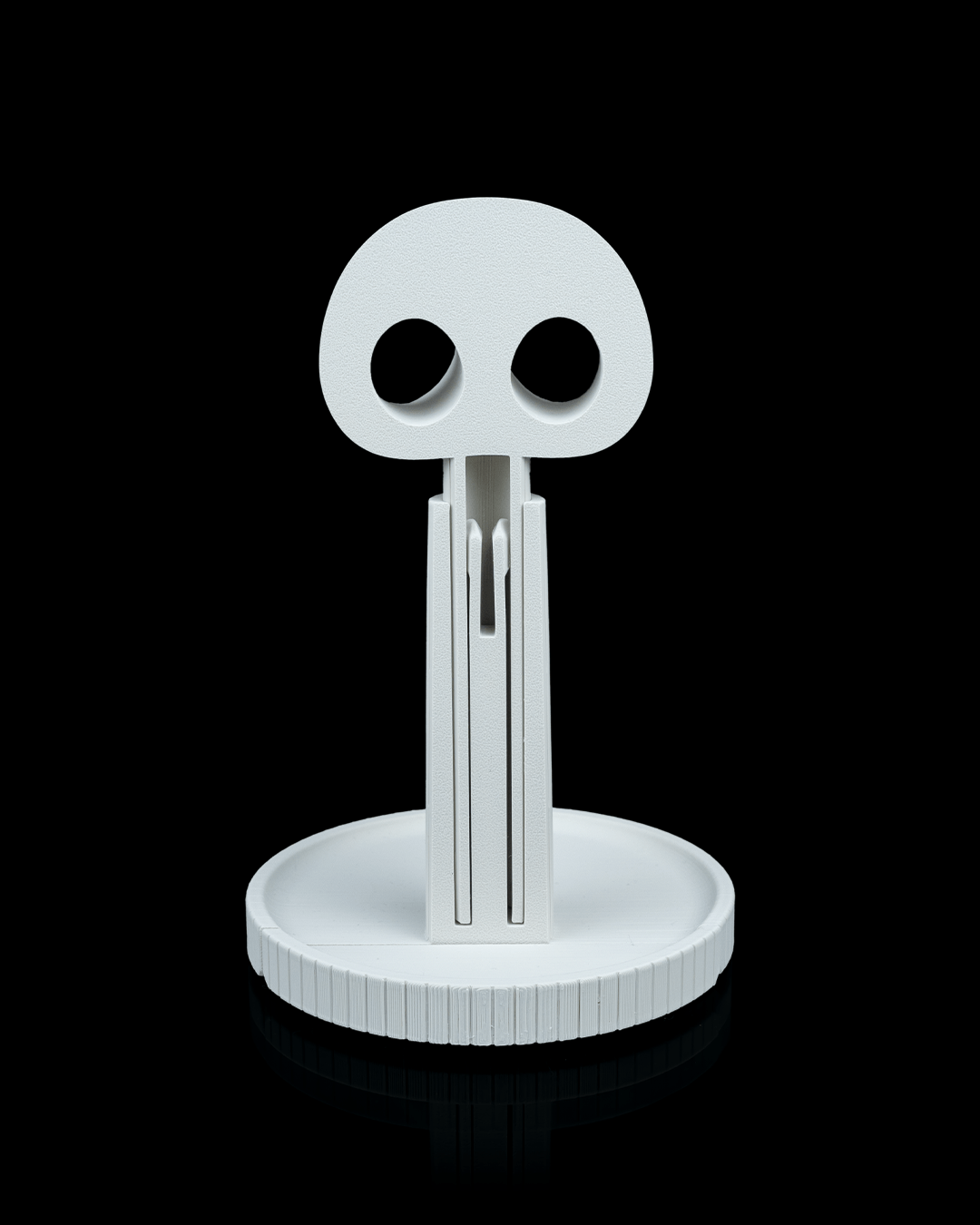 Grimm — a reaper 3D-printed headphone stand — holding headphones in use