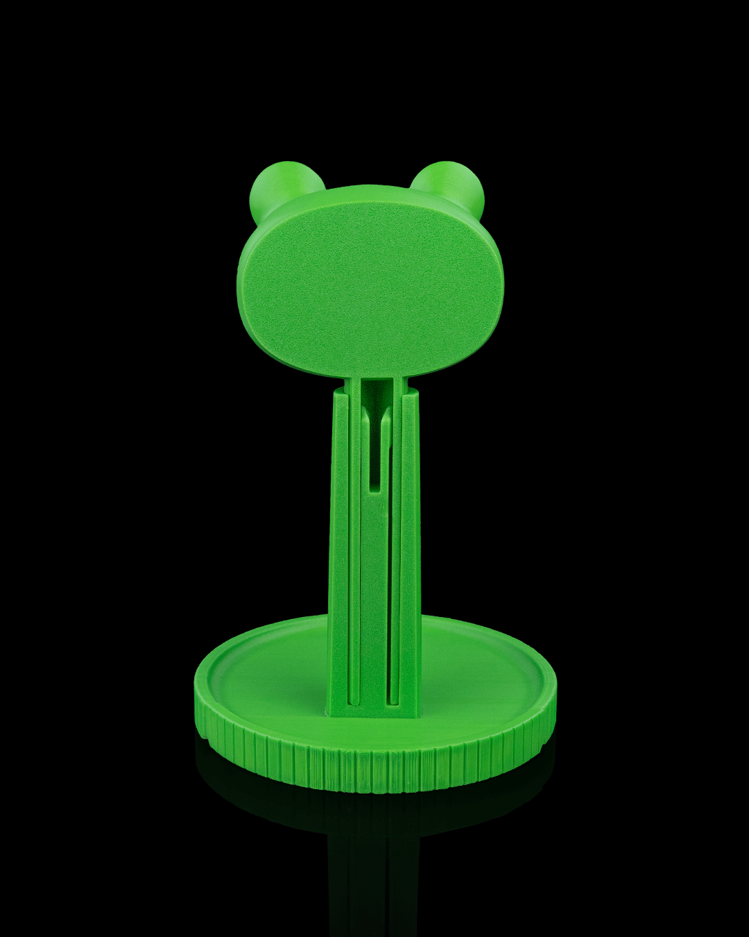 Ribbit — a frog-shaped 3D-printed headphone stand — holding headphones in use