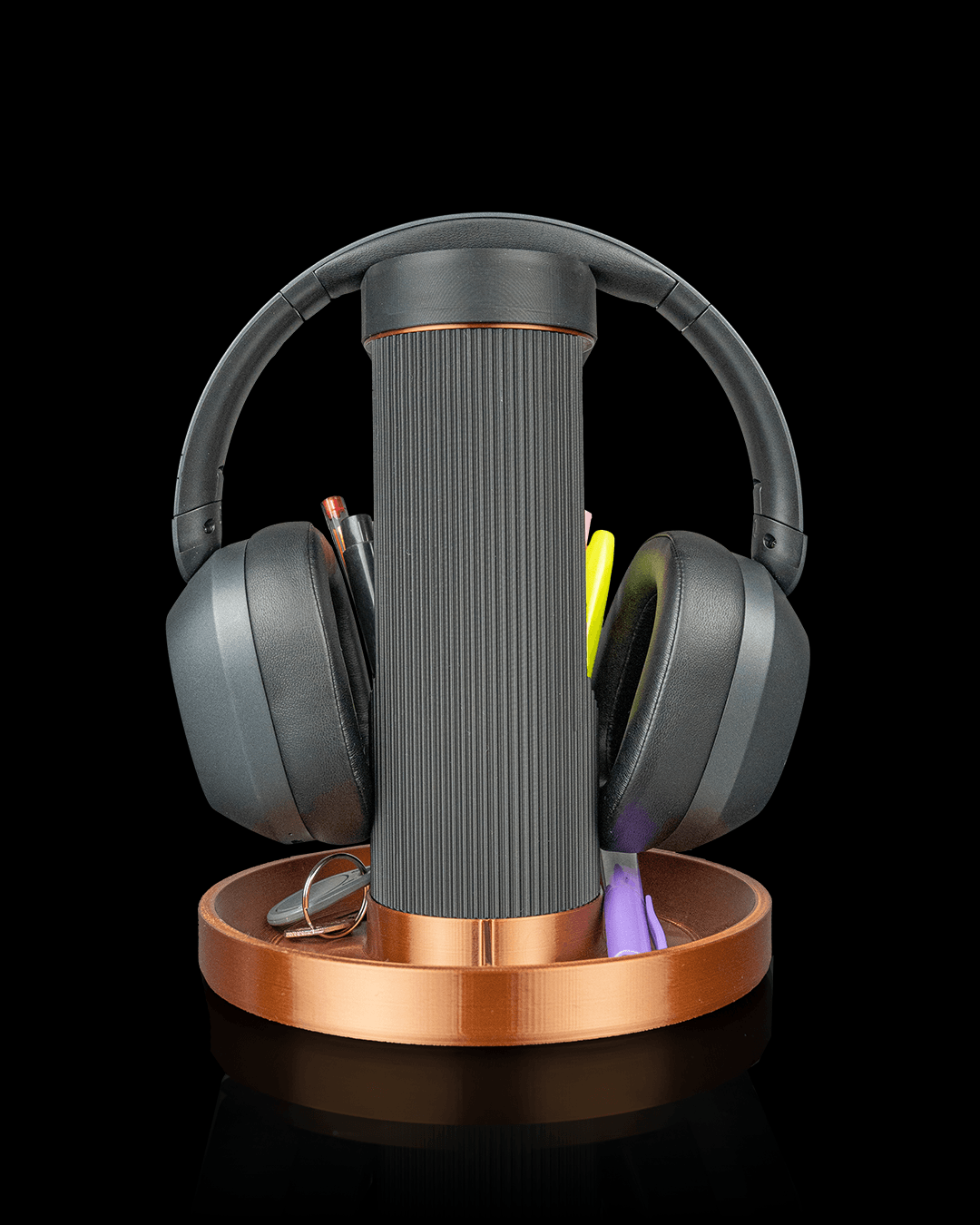 Tower Trio — a 3D-printed headphone and phone holder — holding headphones and phone in use