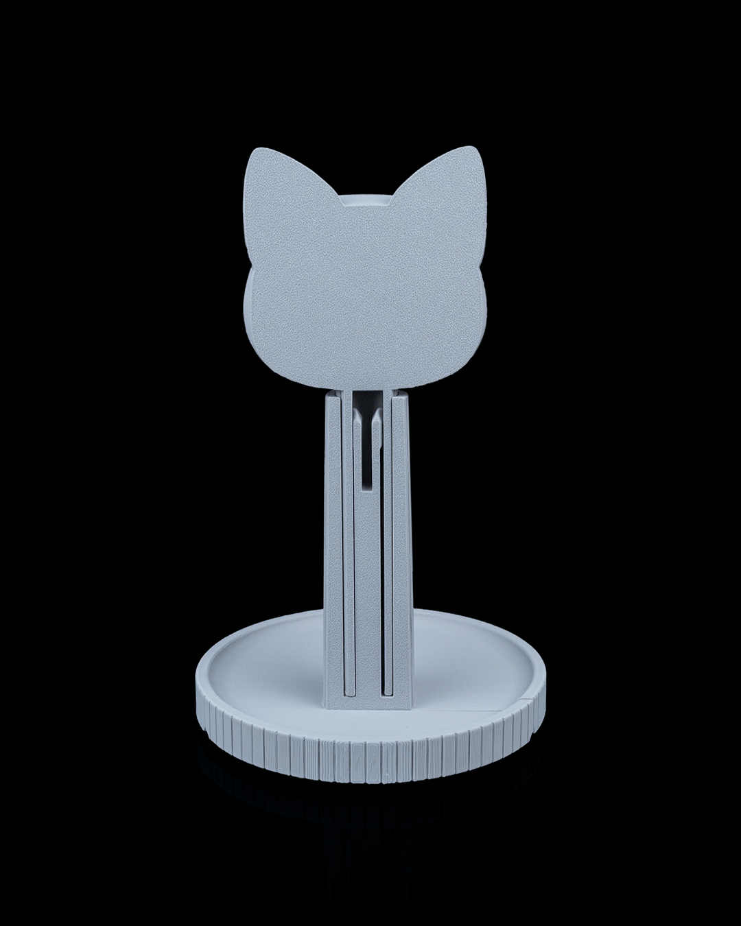 Whiskers — a cat-shaped 3D-printed headphone stand — holding headphones in use