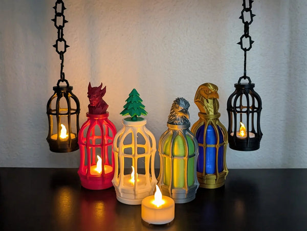 Gothic Tealight Lantern — the full collection lit up: hanging black lanterns, red devil, white tree, silver crow and gold Horus