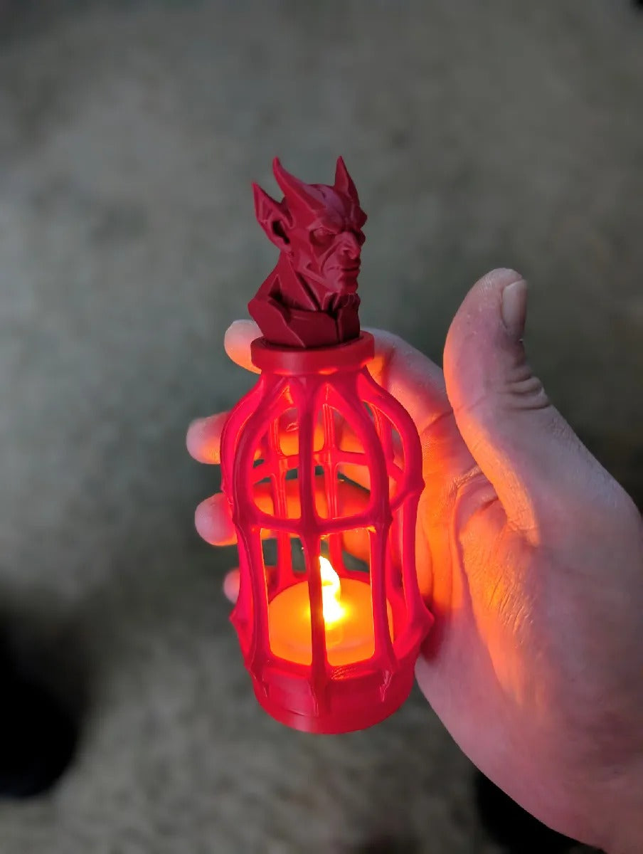 Gothic Tealight Lantern — red lantern with devil bust topper glowing in hand