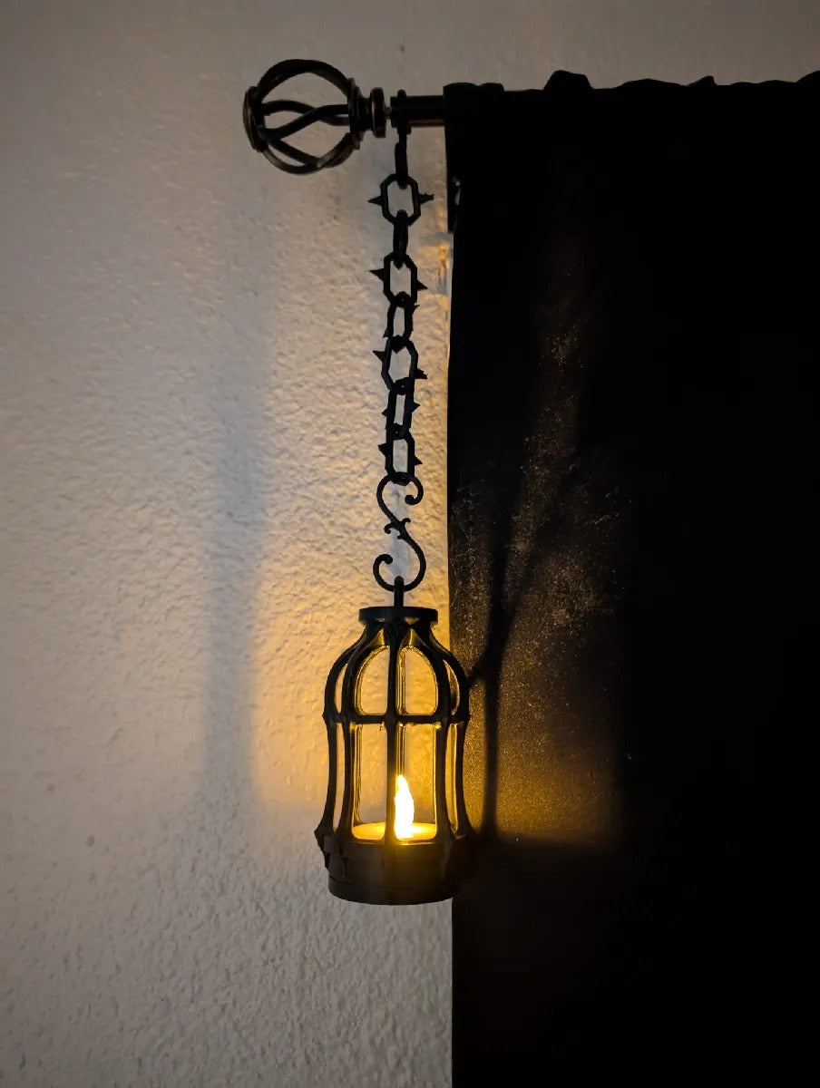 Gothic Tealight Lantern — black lantern hanging from a curtain rod on the spiked chain and S-hook
