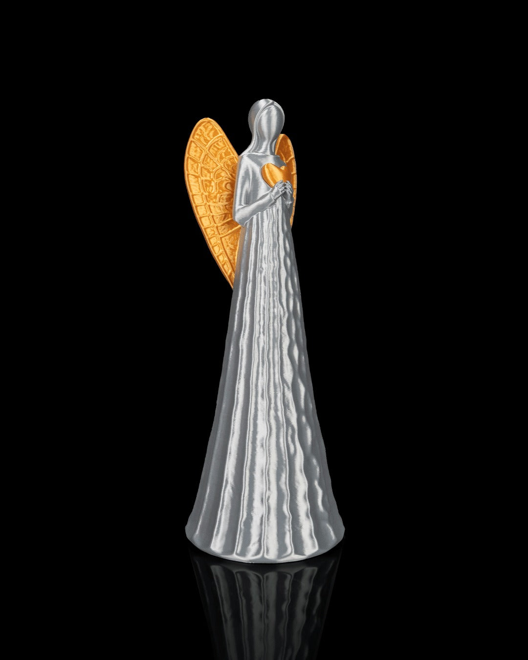 Heavenly Trio — angel holding a gold heart, side view