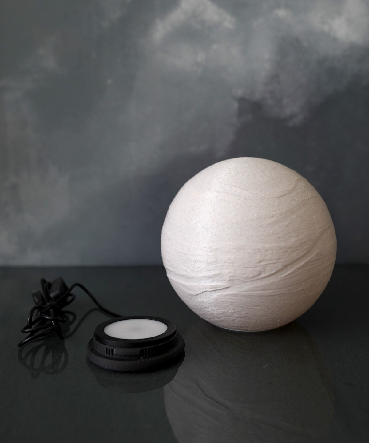 Saturn Planet Lamp — unlit globe showing the raised bands, next to the LED base