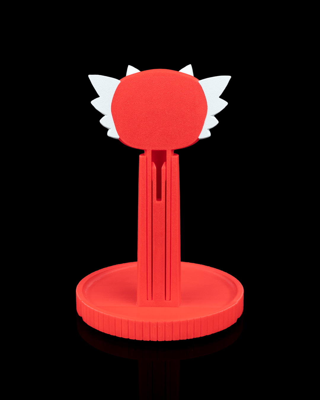 Dragon — a 3D-printed dragon headphone stand — holding headphones in use