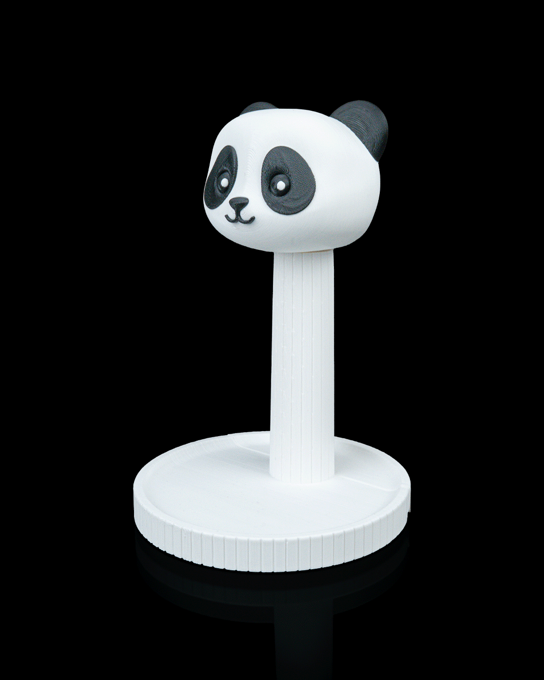Panda — a 3D-printed panda headphone stand — holding headphones in use