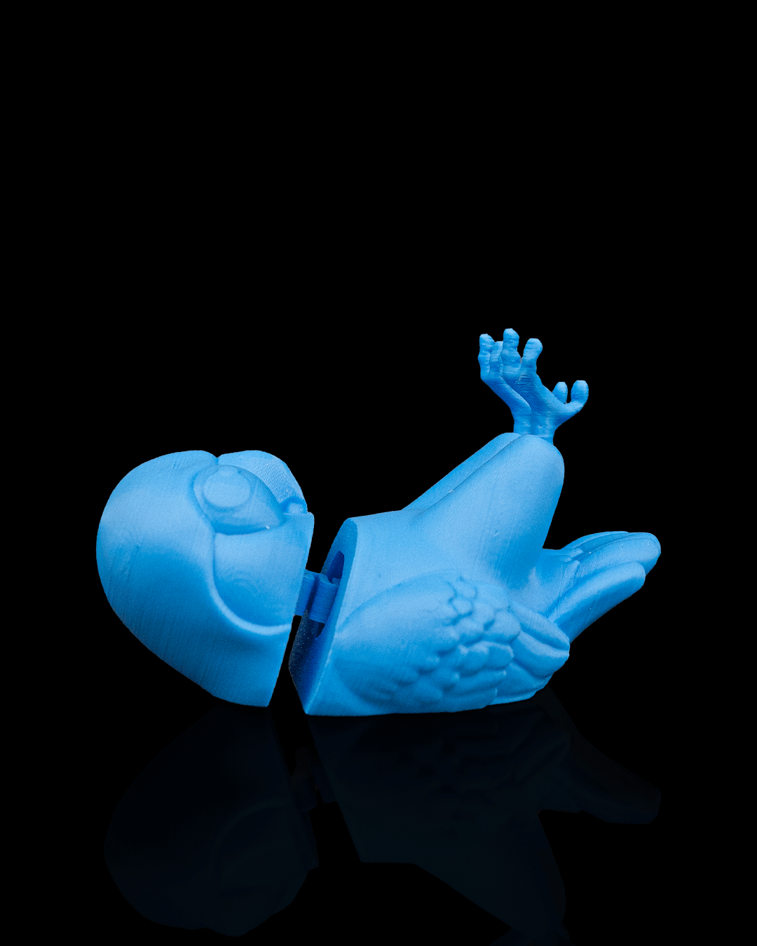 Perchmate — a 3D-printed parakeet glasses holder — holding glasses in use