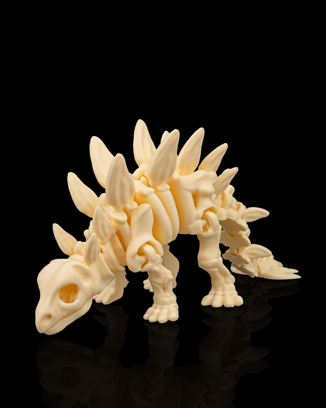 Articulated 3D-printed Stegosaurus dinosaur skeleton — poseable desk figurine (view 1)