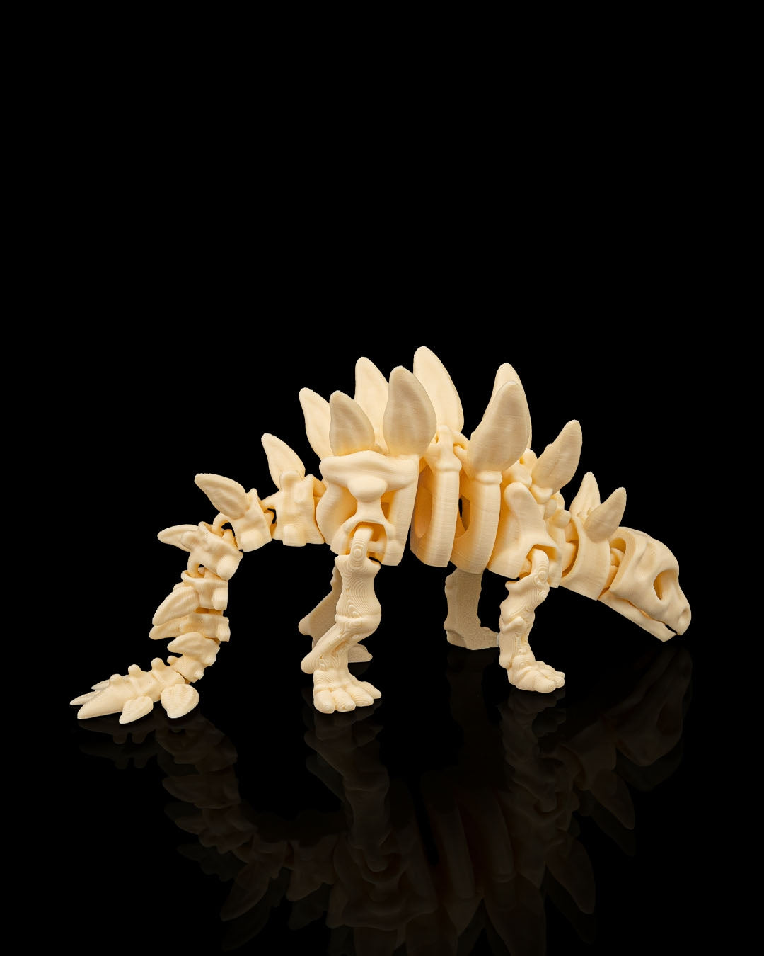 Articulated 3D-printed Stegosaurus dinosaur skeleton — poseable desk figurine (view 4)
