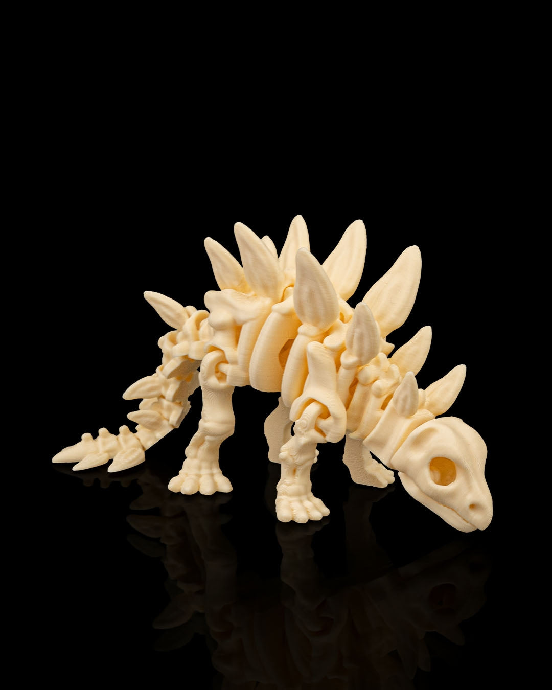 Articulated 3D-printed Stegosaurus dinosaur skeleton — poseable desk figurine (view 5)