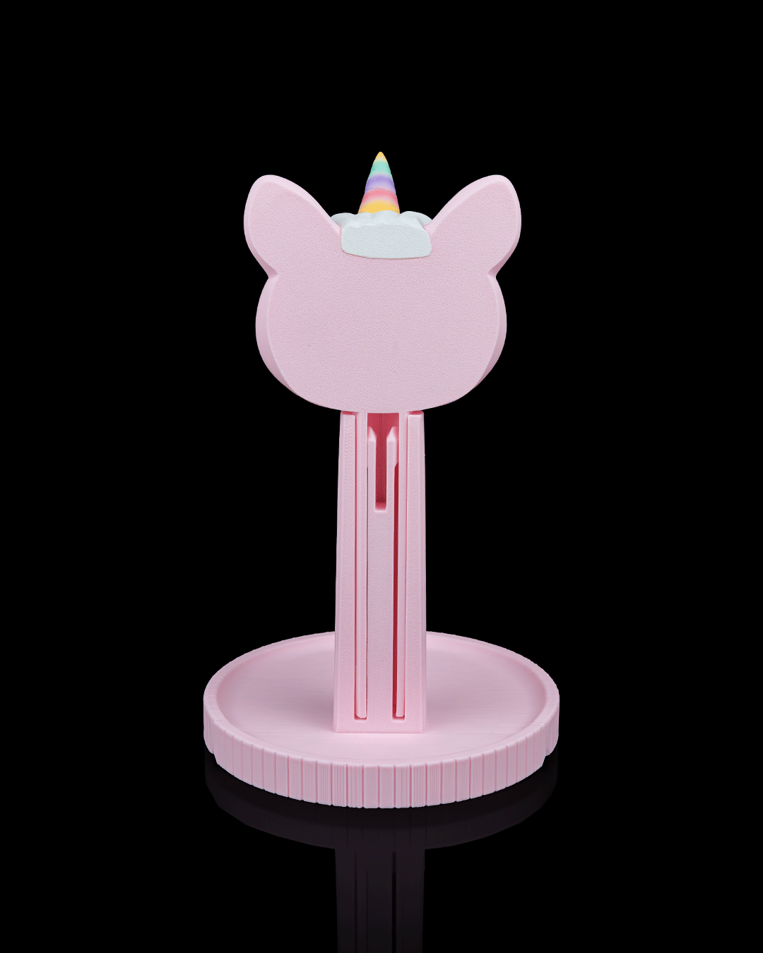 Unicorn — a 3D-printed headphone stand — holding headphones in use