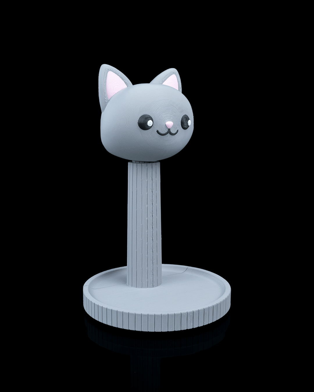 Whiskers — a cat-shaped 3D-printed headphone stand — shown on a desk