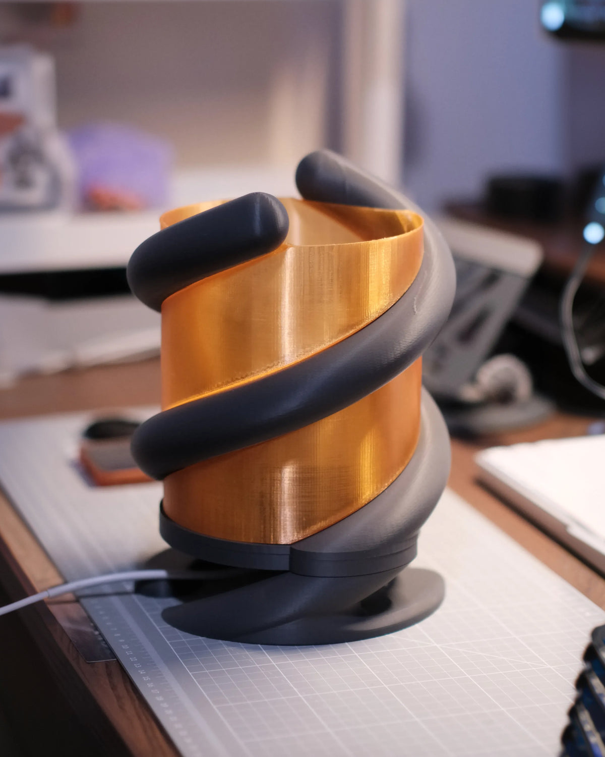 Coil Lamp — side view showing the oval foot and curved leg