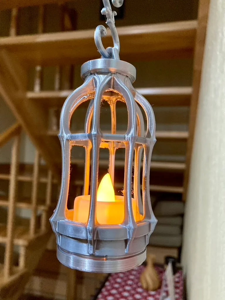 Gothic Tealight Lantern — silver hanging lantern close-up with a lit tealight inside the open cage