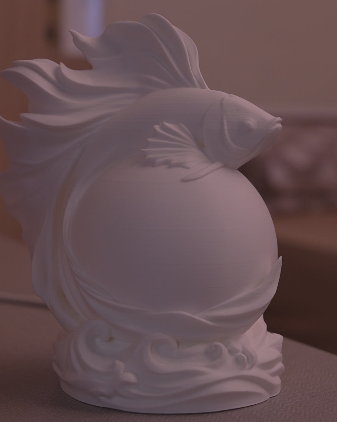 Betta Sphere Table Lamp in motion — 3D-printed betta fish sphere lamp glowing