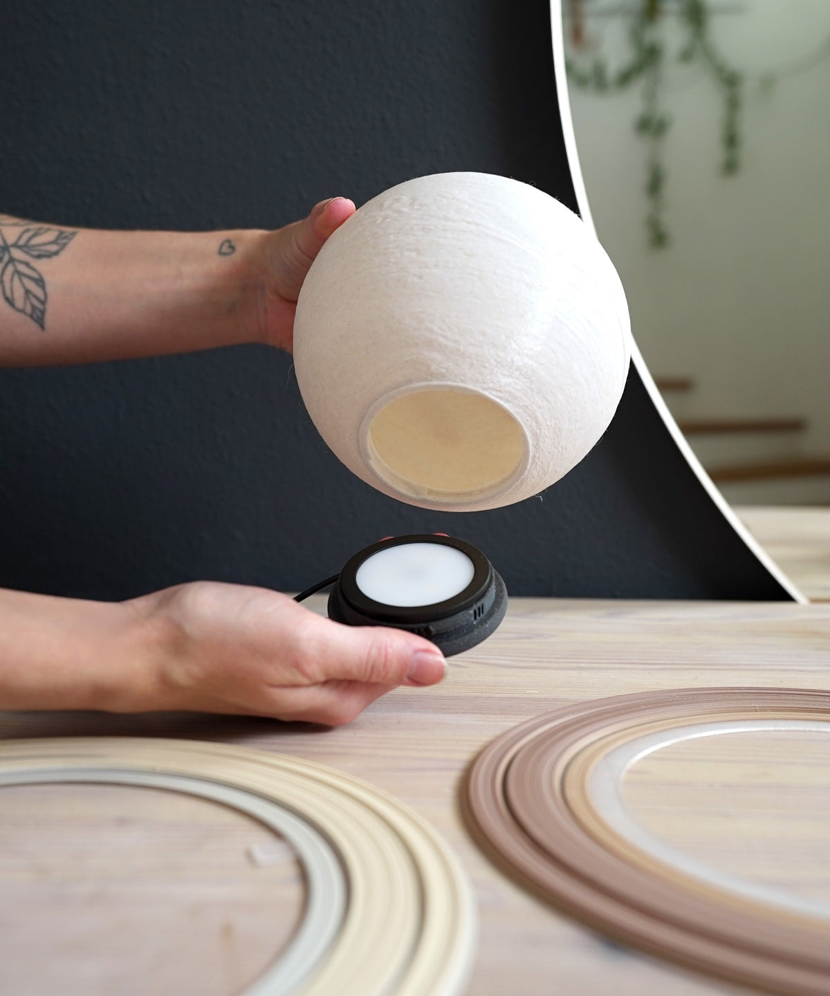Saturn Planet Lamp — globe lifting off the twist-lock LED base, with two rings