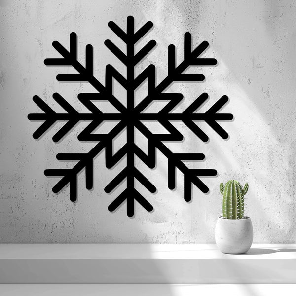 Snowflake Wall Art — shown in black on a wall